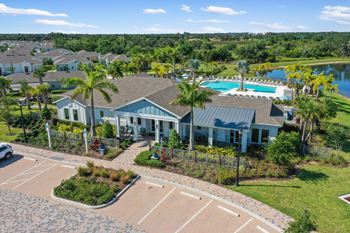 an aerial view of a house with a swimming pool and tennis court